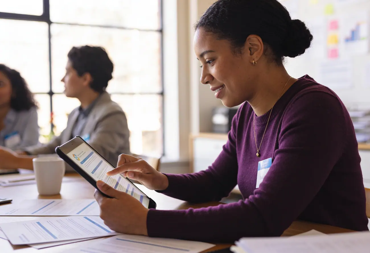 A fundraiser reviewing her campaign plan on a tablet
